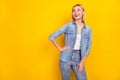 Photo portrait of curious blonde girl smiling wearing jeans outfit looking copyspace isolated vivid yellow color