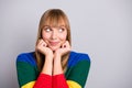 Photo portrait of curious blonde woman looking at empty space touching hands cheeks isolated on pastel grey color