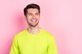 Photo portrait curious brunet man wearing bright t-shirt looking blank space isolated pastel pink color background