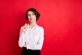 Photo portrait of curious business woman keeping glasses thoughtful looking copyspace isolated bright red color Royalty Free Stock Photo