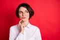 Photo portrait of curious business woman wearing spectacles formal wear smiling looking copyspace isolated bright red