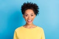 Photo portrait curly woman smiling overjoyed happy in yellow shirt isolated pastel blue color background