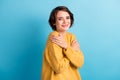 Photo portrait of cute girl embracing hugging herself wearing warm yellow jumper isolated on vibrant blue color Royalty Free Stock Photo