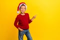 Photo portrait of cute little boy point copyspace christmas north pole wear trendy red knitwear look isolated on yellow