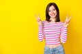 Photo portrait of cute young lady smiling show double v-sign empty space dressed stylish striped look isolated on yellow Royalty Free Stock Photo