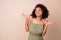 Photo portrait of cute young woman curly hair shrug helpless look empty space dressed trendy khaki look isolated on Royalty Free Stock Photo