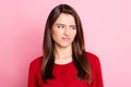 Photo portrait of displeased disgusted young girl with straight brown hair grimacing looking at side isolated on pink Royalty Free Stock Photo