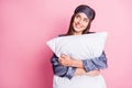 Photo portrait of dreamy girl hugging pillow looking at blank space isolated on pastel pink colored background Royalty Free Stock Photo