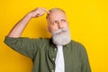 Photo portrait of elder man looking blank space thinking about idea isolated bright yellow color background Royalty Free Stock Photo