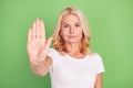 Photo portrait elder woman showing stop sign with hand isolated on pastel green color background