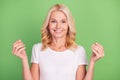 Photo portrait elder woman smiling asking money in white t-shirt isolated on pastel green color background Royalty Free Stock Photo