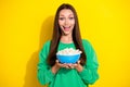 Photo portrait of excited young girl hold popcorn bowl ready watch film dressed trendy green sweatshirt isolated on