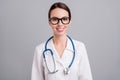 Photo portrait female doctor with sthethoscope smiling wearing glasses  grey color background Royalty Free Stock Photo