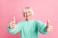 Photo portrait of female pensioner bob hairstyle demonstrating thumb-up sign like isolated on pastel pink color