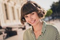 Photo portrait female student in striped shirt smiling overjoyed having nice mood in sunny weather