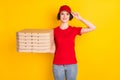 Photo portrait of female worker keeping pile of boxes smiling isolated on vivid yellow color background