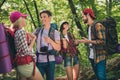 Photo portrait four girls and guys communicating smiling walking in forest camping wearing backpacks