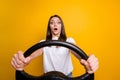 Photo portrait of frightened nervous brunette girl practicing driving first time isolated on vibrant yellow color