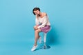 Photo portrait full body view of adorable girl resting head on hand sitting on bar stool isolated on pastel blue colored Royalty Free Stock Photo