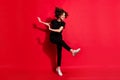 Photo portrait full body view of happy girl kicking dancing raising leg isolated on vivid red colored background Royalty Free Stock Photo