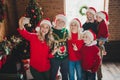 Photo portrait of full family spending time together near christmas tree taking selfie showing v-sign gesture Royalty Free Stock Photo