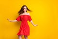 Photo portrait of funky girl laughing in red fancy printed dress dancing at party isolated vivid yellow color background Royalty Free Stock Photo