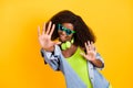 Photo portrait of funky woman laughing in headphones giving high five isolated vibrant yellow color background copyspace