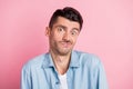 Photo portrait of funny unsure man doubtful grimacing shrugging shoulders not know isolated pastel pink color background