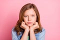 Photo portrait girl bad mood grumpy face unhappy  pastel pink color background Royalty Free Stock Photo