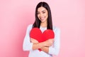 Photo portrait of girl embracing lovely red heart smiling on valentines day isolated on pastel pink color background