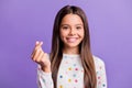 Photo portrait of girl making korean heart with fingers isolated on bright purple colored background