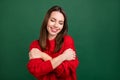Photo portrait girl in red pullover dreamy embracing herself smiling isolated green color background Royalty Free Stock Photo