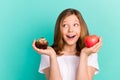 Photo portrait girl scaling sweet cupcake apple looking blank space overjoyed isolated vivid teal color background Royalty Free Stock Photo