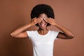 Photo portrait of girl shut eyes with hands smiling overjoyed playing game isolated on brown color background