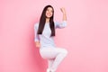 Photo portrait of girl smiling gesturing like winner isolated on pastel pink color background Royalty Free Stock Photo