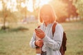 Photo portrait of girl student holding phone and laptop smiling outdoors in the park Royalty Free Stock Photo