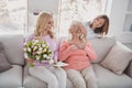 Photo portrait of granddaughter shut eyes of granny making surprise with postcard tulips flowers bunch