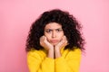 Photo portrait of grumpy moody depressed girl curly hairstyle isolated on pastel pink background