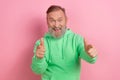 Photo portrait of handsome senior man point you excited hey wear trendy green garment isolated on pink color background Royalty Free Stock Photo