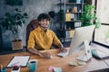 Photo portrait of handsome young guy wear yellow shirt cheerful startup administrator workplace stylish room interior