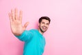 Photo portrait of handsome young man raise hand arm wave hello high five dressed stylish blue outfit isolated on pink