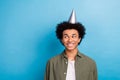 Photo portrait of handsome youngster man funny chevelure hair looking empty space happy birthday cone isolated on blue