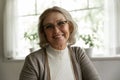 Photo portrait of happy elder OAP 60s woman wearing glasses