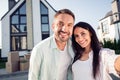 Photo portrait of happy family couple wife husband smiling outdoors new home after moving relocating Royalty Free Stock Photo