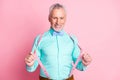 Photo portrait of happy old metrosexual smiling keeping suspenders wearing bowtie shirt isolated on pink color Royalty Free Stock Photo