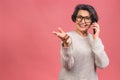 Photo portrait of happy senior mature aged woman holding mobile phone, grandmother wearing casual isolated on pink background.