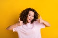 Photo portrait of happy woman showing two thumbs up isolated on vivid yellow colored background Royalty Free Stock Photo