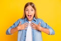 Photo portrait of impressed shocked schoolgirl showing on herself shouting surprised wearing denim shirt isolated on