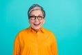 Photo portrait of laughing crazy pensioner grandmother in good mood have fun wearing orange shirt isolated on aquamarine