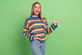 Photo portrait laughing girl wearing striped pullover showing blank space amazed isolated pastel green color background Royalty Free Stock Photo